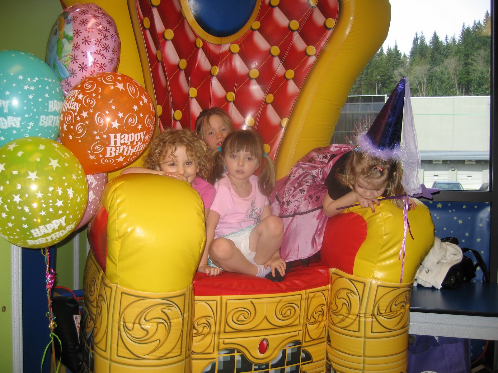 Dahlia and her friends sit on the huge birthday throne